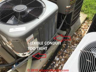 Flexible AC whip stretched too tight at AC condenser unit (C) InspectApedia.com Dan