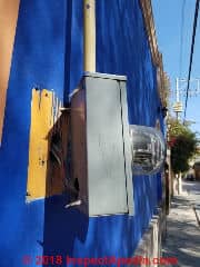 Electric meter pulling off of a building in San Miguel de Allende (C) Daniel Friedman at InspectApedia.com