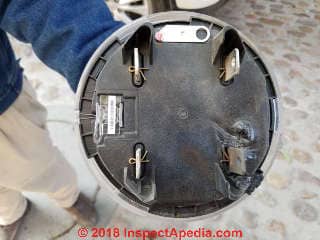Burned under-side of an electric meter following an overheated aluminum SEC connector (C) Daniel Friedman at InspectApedia.com