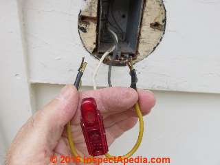 Using a neon tester to check for power at electrical wires (C) Daniel Friedman