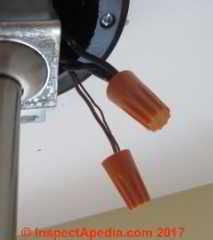 Twist on connectors connecting both ground and hot wire ends at a ceiling light (C) Daniel Friedman