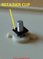 Plastic retainer clip on an electrical receptacle or switch cover screw (C) Daniel Friedman at InspectApedia.com