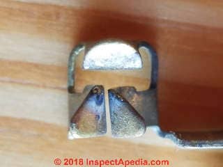 Hot terminal in receptacle showing arc pitting may be due to a parting arc (C) Daniel Friedman at InspectApedia.com