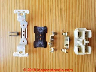 Components of the 1962 damaged electrical receptacle (C) Daniel Friedman at InspectApedia.com