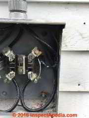 SEC wire damaged in electric meter pan (C) InspectApedia.com PA DF