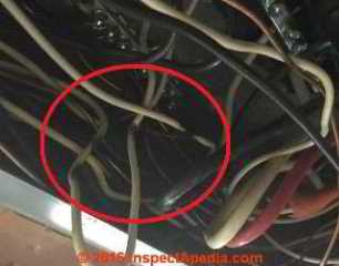 Burns on electrical wires in the electrical panel following SEC short of hot to system ground (C) InspectApedia.com DF PA