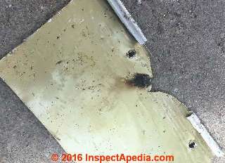 Electrical arc burn marks on the back of aluminum siding (C) InspectApedia.com PA DF