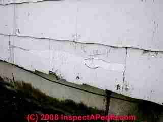 Photograph of - damaged vinyl siding