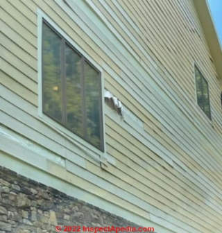 Buckled fiber cement siding, also curled, loose, falling off, leaks, hidden damage (C) InspectApedia.com JN Tennessee