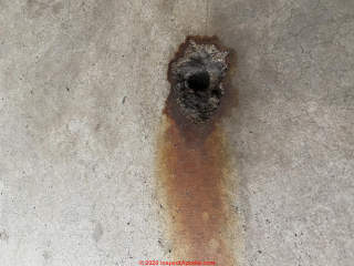 Iron incluion stain on concrete garage floor (C) InspectApedia.com kpmassy