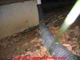 Downspout spills below deck © D Friedman at InspectApedia.com 