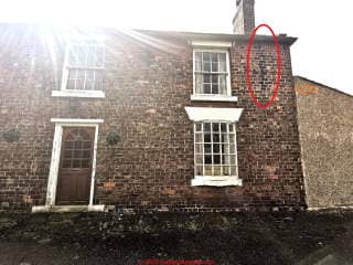 Black stains on brick wall below gutters (C) InspectApedia.com Bex