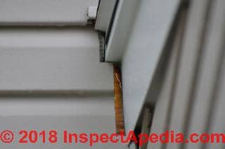 Wet area on foundation below siding may come from siding leak higher on wall (C) Inspectapedia.com JJ 