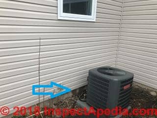 Wet area on foundation below siding may come from siding leak higher on wall (C) Inspectapedia.com JJ 