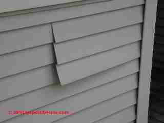 Damaged vinyl siding (C) Daniel Friedman