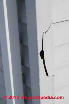 Damaged vinyl siding corner trim (C) InspectApedia.com Daniel Friedman