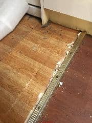 Asbestos-suspect vinyl flooring (C) InspectApedia.com 