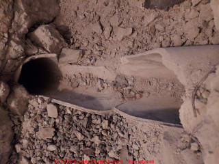 In-slab ductwork, damaged, MIGHT be transite asbestos-cement - (C) InspectApedia.com Sam Labaidi