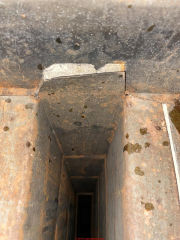 Apparent asbestos gasket exposed in air path in HVAC duct - wet rusty ductwork (C) InspectApedia.com Joe