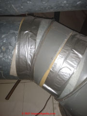 Asbestos paper duct tape taped over with modern duct tape (C) Inspectapedia.com ANW