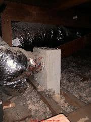 Asbestos paper wrapping on heating duct air supply register box after ductwork was replaced (C) InspectApedia.com James