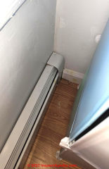 baseboard pipe routing through wall (C) InspectApedia.com Anon