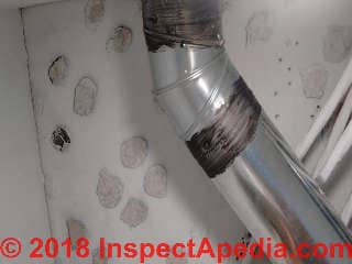 Obstructed ceiling tile test for asbestos (C) InspectApedia.com Herschel H Dvinci at InspectApedia.com