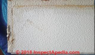 Firbrous ceiling tile may contain asbestos (C) InspectApedia.com Phil