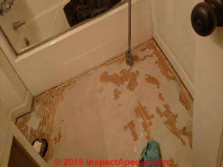 Floor backer remaining during stripping may contain asbestos (C) InspectApedia.com Marie