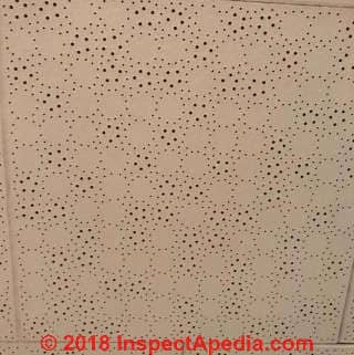 Perforated ceiling tile hazards during drilling (C) InspectApedia.com Christine