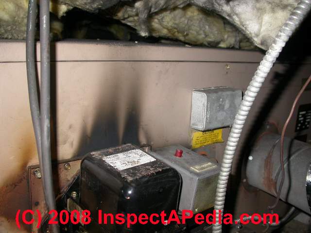 What causes a furnace to smell like oil when turned on?