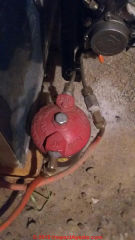 Looking for the air bleeder fitting on an unusual oil burner pump on a Beckett burner (C) InspectApedia.com Colin