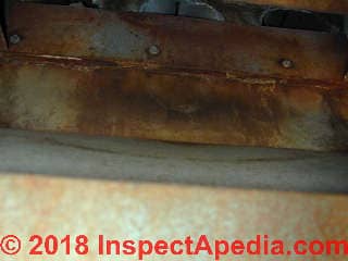 Rusty furnace leaky heat exchanger is dangerous possibly fatal carbon monoxide poisoning (C) InspectApedia.com