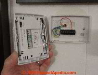 Old thermostat opened to reveal wires and batteries (C) Daniel Friedman