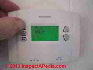 Positioning new wall thermostat in place (C) Daniel Friedman