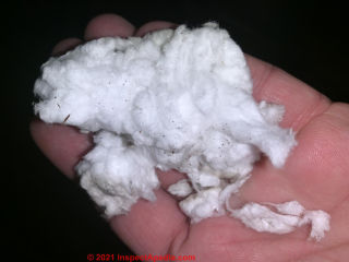 White mineral wool insulation from an 1890 home (C) InspectApedia.com Shaun