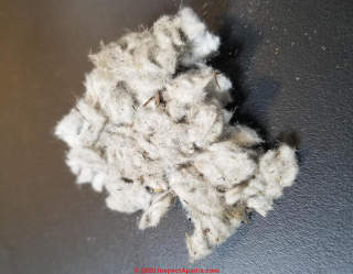 White fibrous insulation may be mineral wool (C) InspectApedia.com Clifford