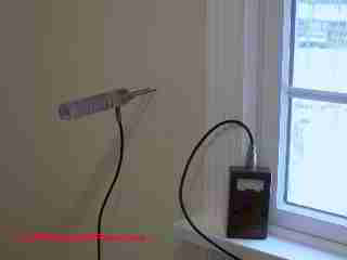 Moisture meter check for waer in walls © D Friedman at InspectApedia.com 