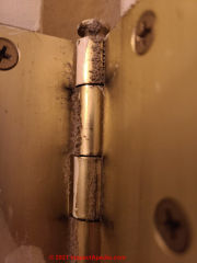 Dust deposits on door hinge - not mold (C) InspectApedia.com Amanda