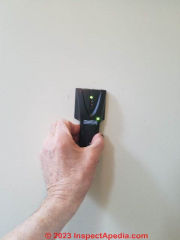 Use a stud finder to locate wall studs when installing a grab bar or grabrail (C) Daniel Friedman at InspectApedia.com