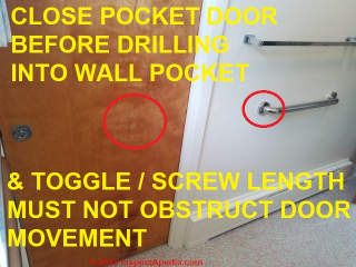 Special care needed when mounting a grab rail on a door into which a pocket door is recessed (C) Daniel Friedman at InspectApedia.com