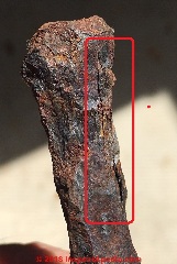Closeup of hand wrought iron spike (C) InspectApedia.com LaCorte