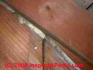 UFFI foam insulation visible in a gap between building sheathing boards © Daniel Friedman