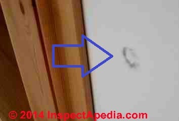 Dark spot stains on interior wall traced to steel wool pads (C) InspectApedia PW