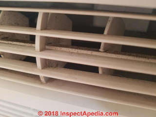 Mold on split system air conditioner wall unit vents (C) InspectApedia.com KC