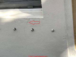 Hairline exterior stucco crack in Florida Townhouse (C) InspectApedia.com Nathanson