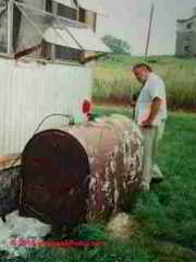 Steve Vermilye inspecting the oil storage tank at a mobile home park (C) Daniel Friedman