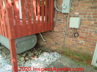 Granby heating oil tank outside under a porch - on its "side" (C) InspectApedia.com Kahn