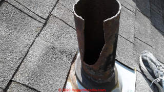 Broken cast-iron plumbing vent above the roofline (C) InspectApedia.com David