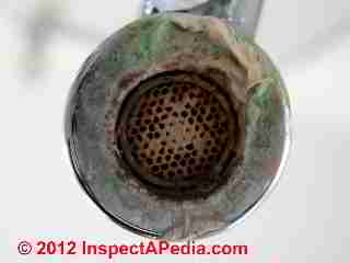 Deposits and stains on faucet strainer © D Friedman at InspectApedia.com 
